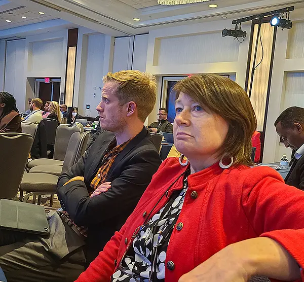 Adam Preston and Eileen Reynolds attend a session at the 2022 DHIS2 Symposium.