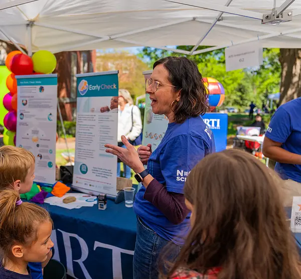 Visitors at RTI's booth at the UNC Science Expo in April 2024
