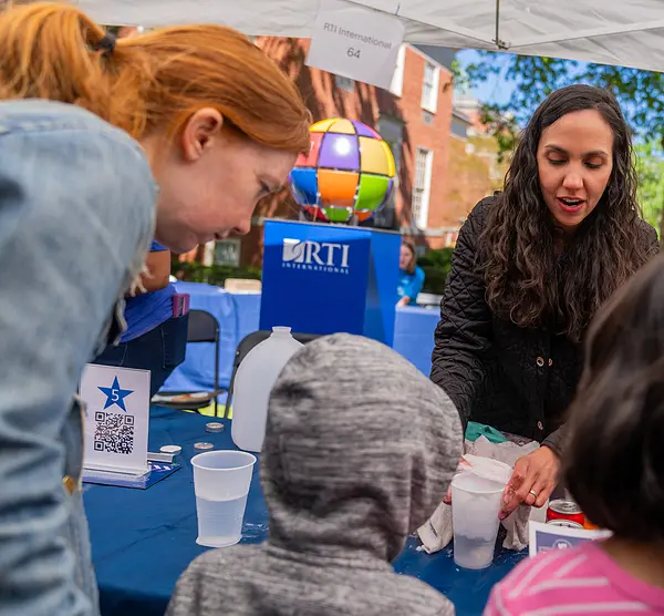 Visitors at RTI's booth at the UNC Science Expo in April 2024
