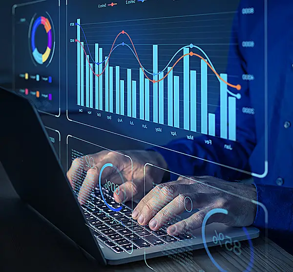 A closeup of a computer monitor and keyboard, with a user searching for visual data.