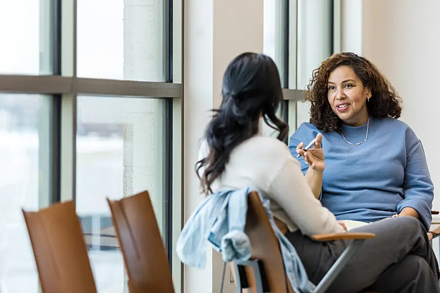 Two women talking at a table