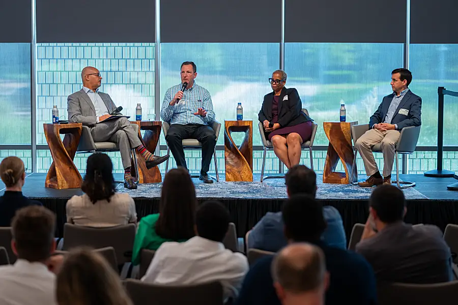 Photo of four panelists at RTI on stage having a discussion