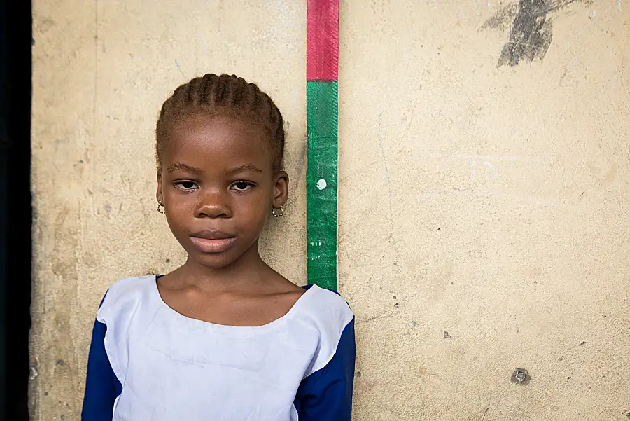 A young girl is measured using a dose pole during an NTD campaign in Cross River State, Nigeria.