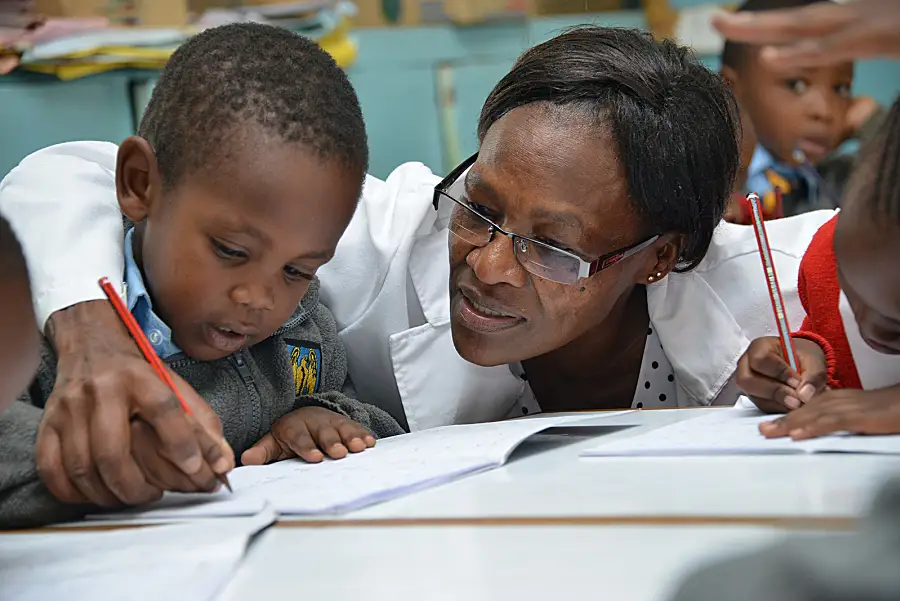 A teacher works with a child in the Tayari early education program in Kenya.