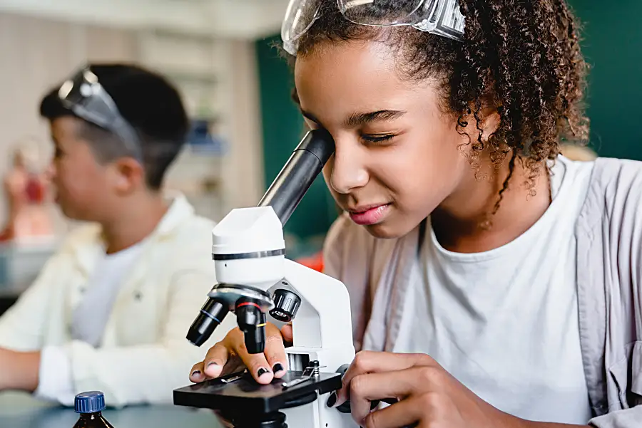 female student looking into telescope