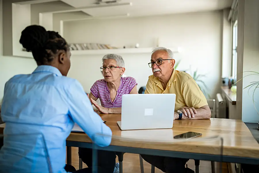 Senior couple sitting with an advisor