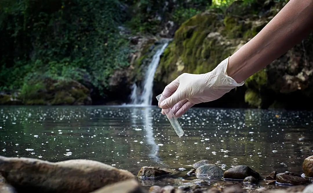 scientest testing a body of water