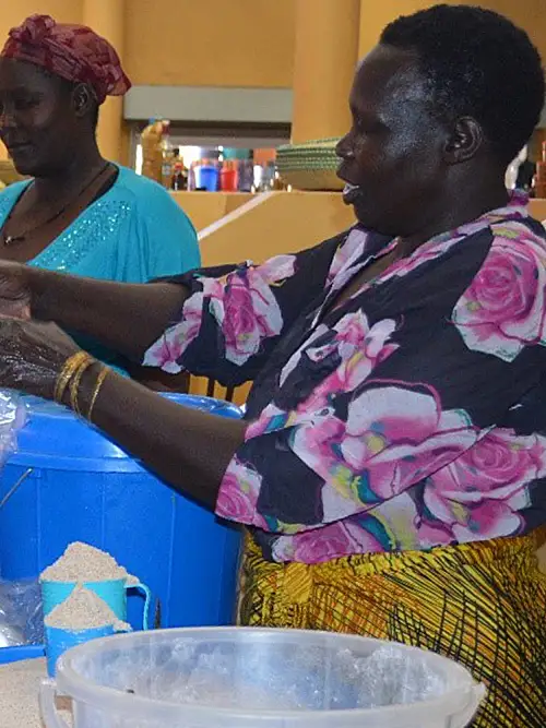 Vendors prepare for the day at the market in Arua