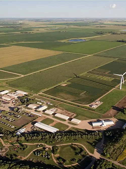 Aerial shot of farmland with wind turbines