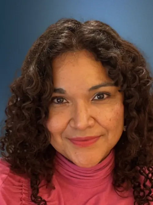 Headshot of Daniela Pineda smiling against a blue background