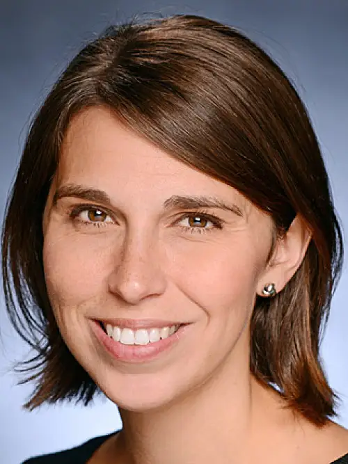 Headshot of Heather Danysh smiling against a blue background