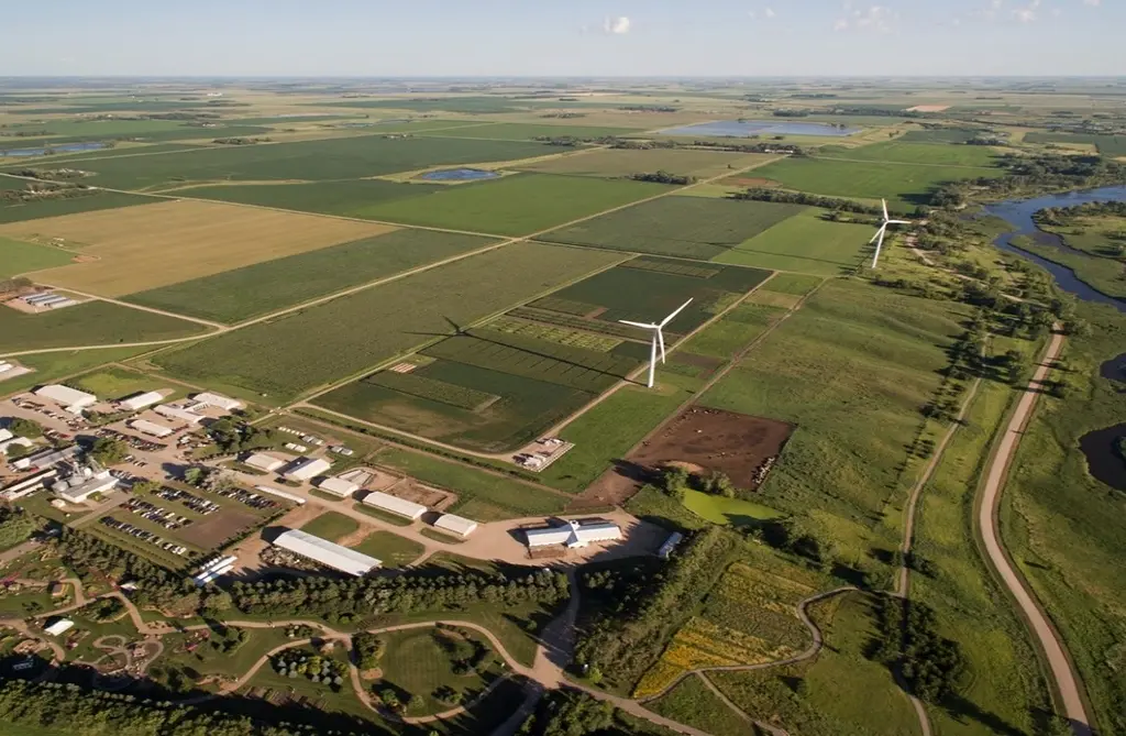 Aerial shot of farmland with wind turbines