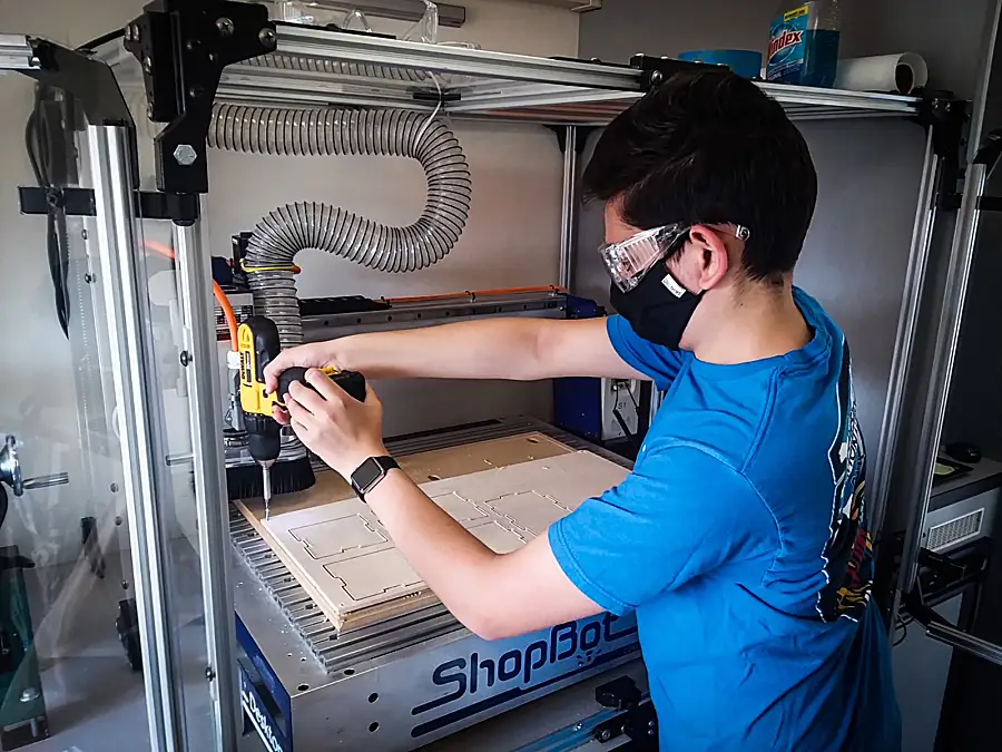 Student using a power drill 