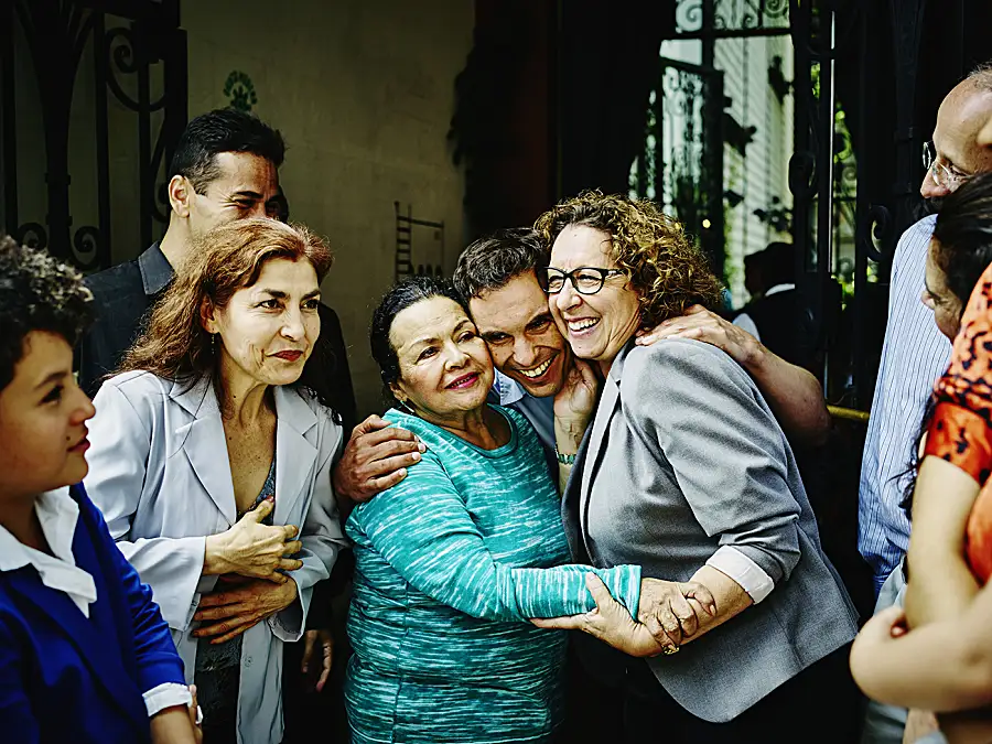 A Hispanic family gathers for a party at a restaurant.