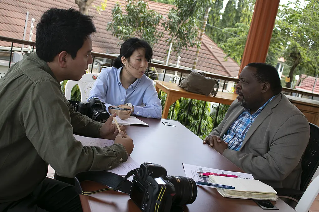 Thai journalists interview a conservation administrator in Tanzania during a journalist exchange organized by USAID PROTECT.