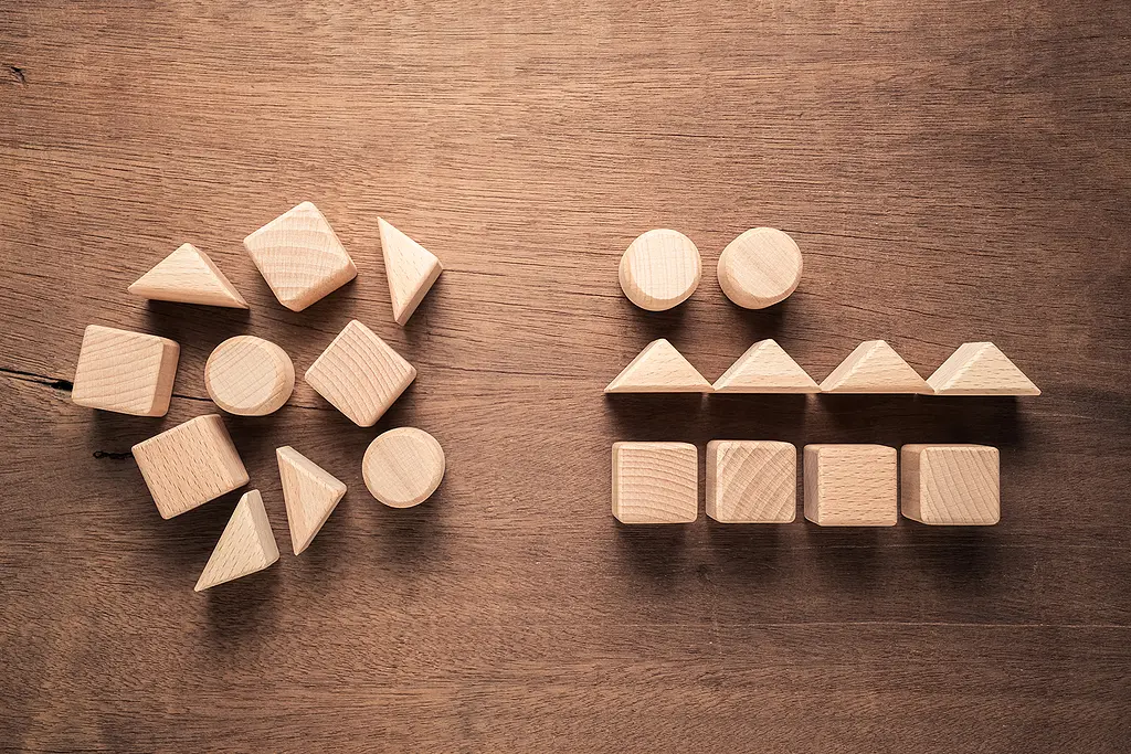 Two sets of plain wooden blocks: one jumbled, one sorted by shape.