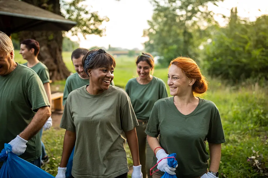 A group of volunteers smiling outdoors