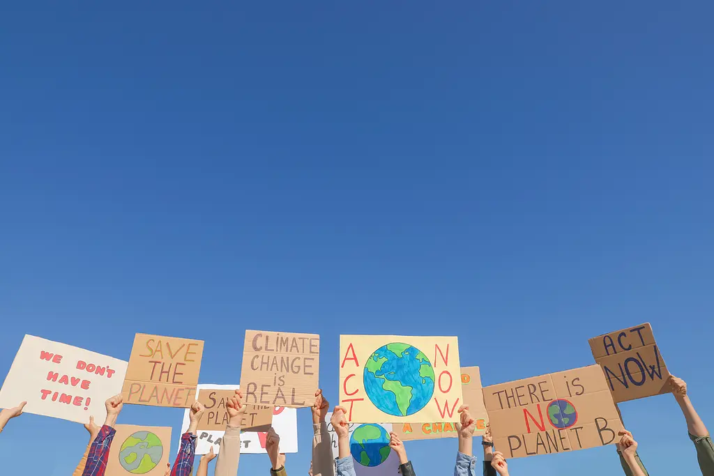 Children holding up climate change signs