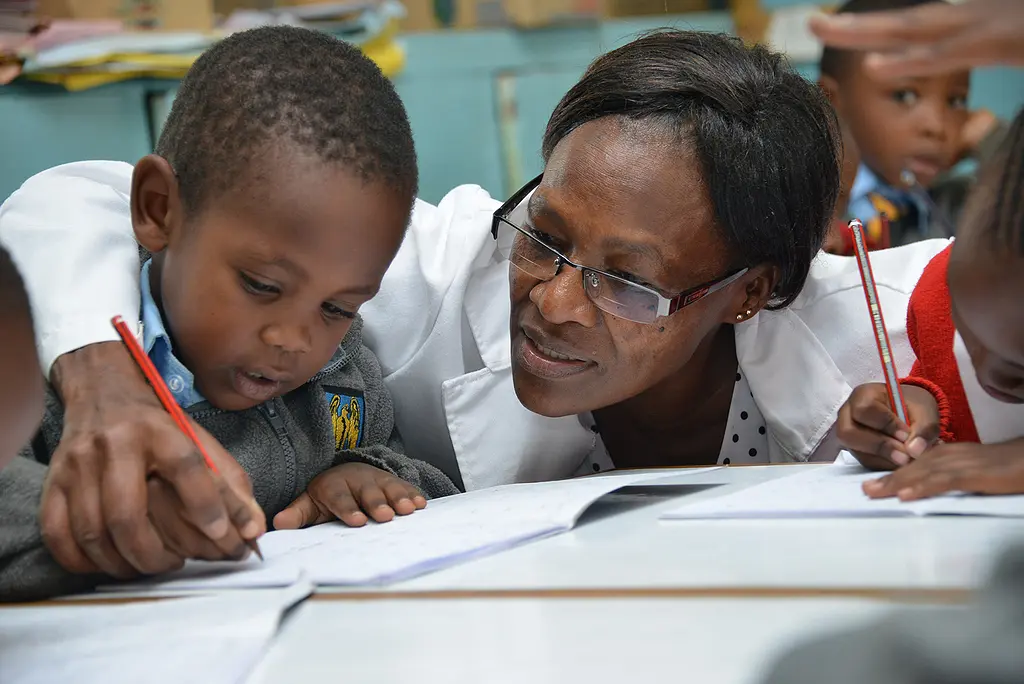 A teacher works with a child in the Tayari early education program in Kenya.