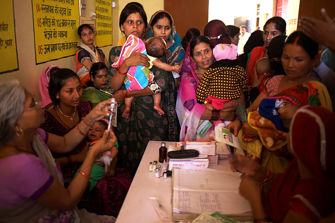 A crowd of women waiting to check in at a health facility in India.