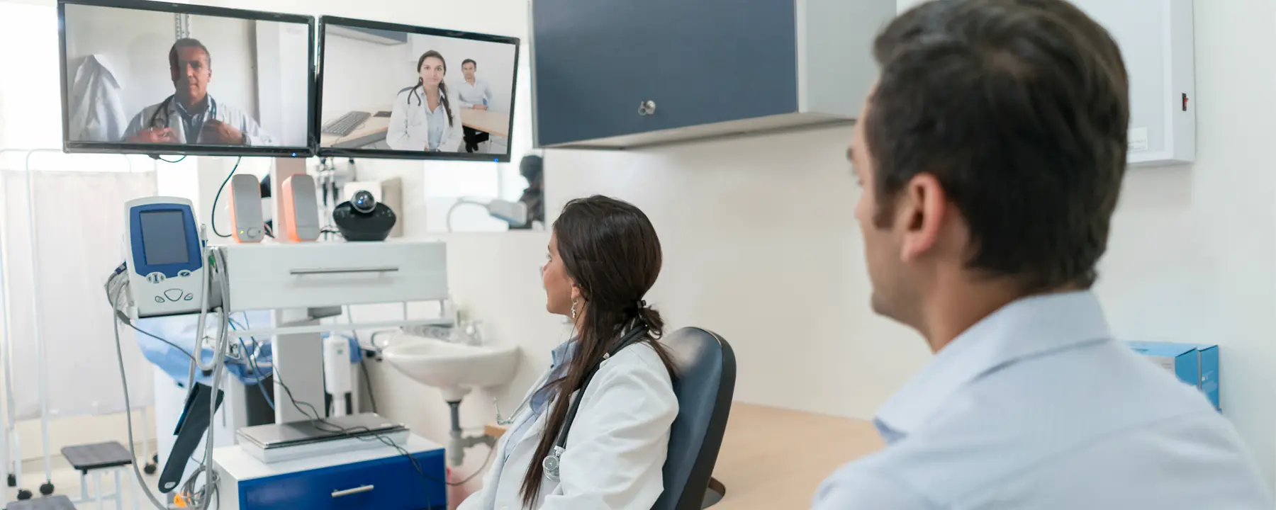 Doctors consult with one another via teleconference.