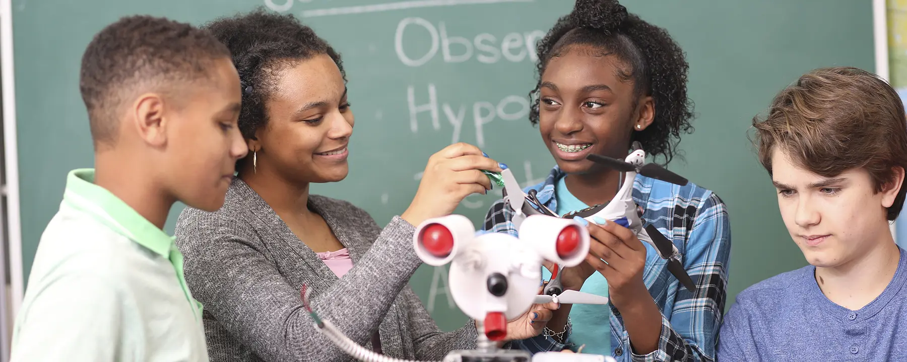 Students looking at a robot