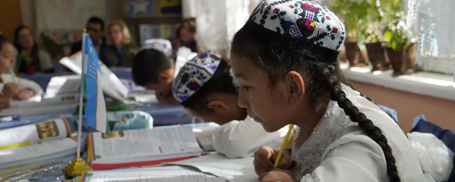 A girl practices reading in her classroom in Uzbekistan.