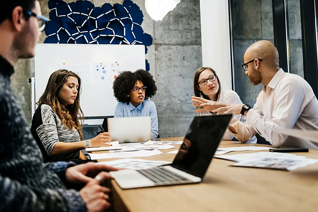 A group of people talking in an office