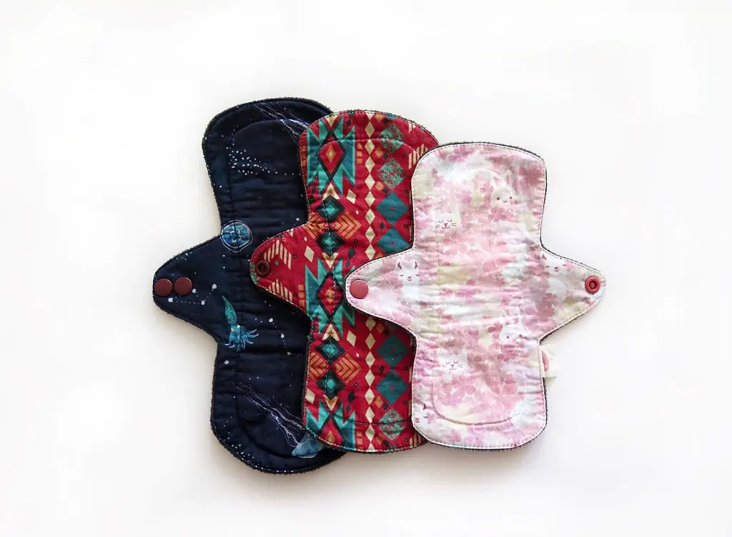 Three colorful reusable menstrual pads