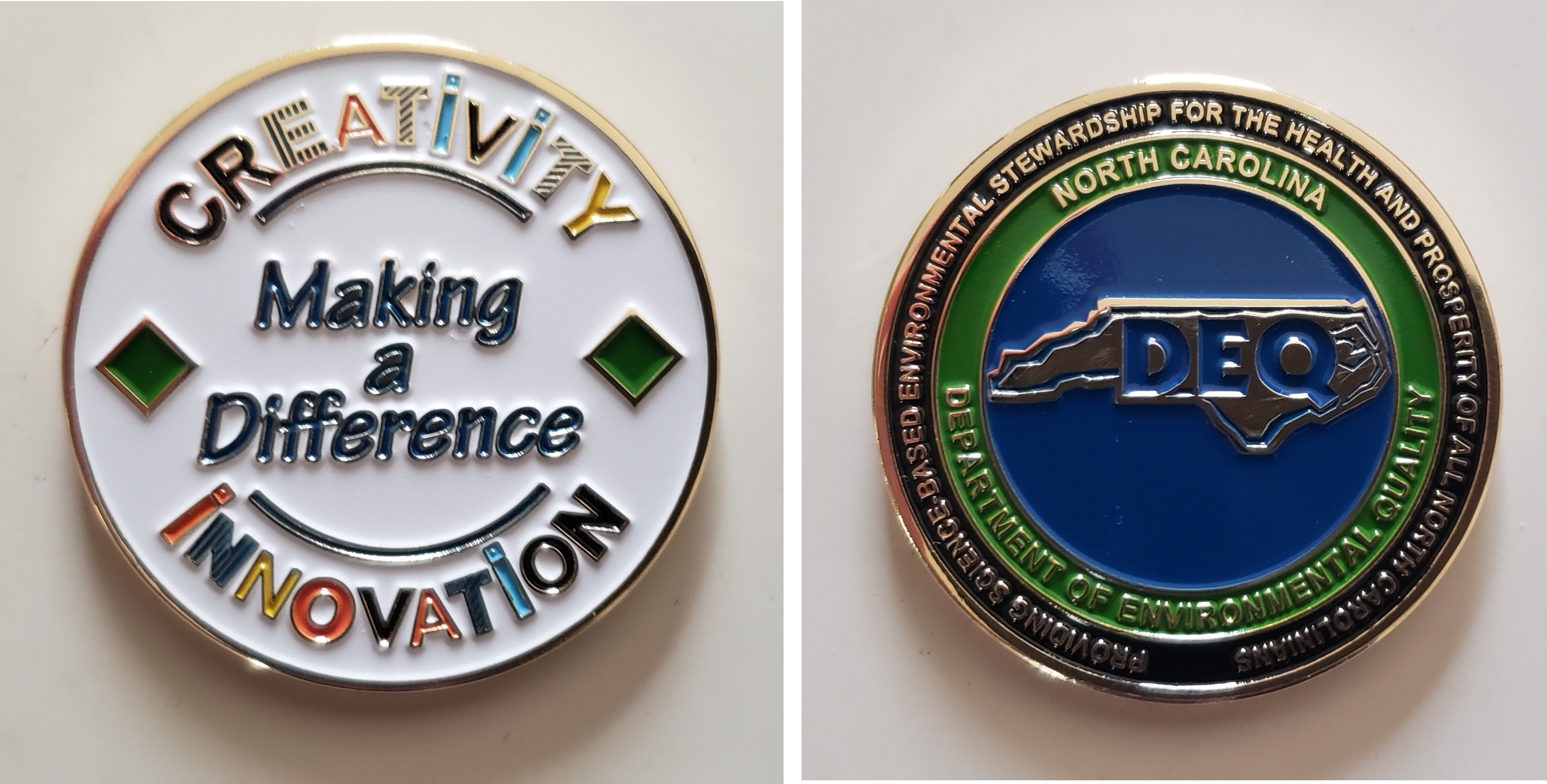 Two decorative coins display phrases promoting creativity and environmental stewardship, each featuring distinctive designs.