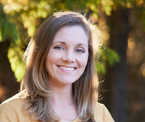 Headshot of Kristen Stolka, showing her smiling outdoors