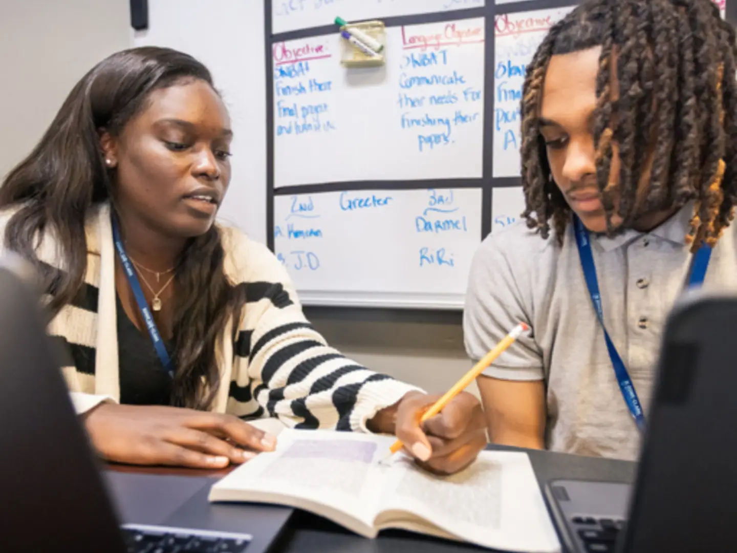 Female teacher teaching male teenage student