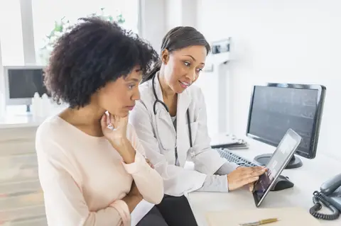 doctor and patient reviewing charts