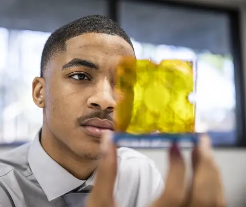 Young scientist examines sample