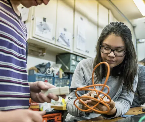 Young student works on project in classroom