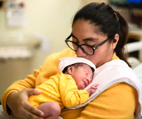 Mother nurses infant