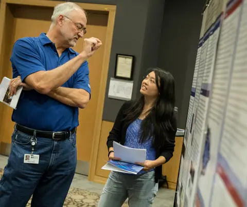 RTI President Wayne Holden meets intern Vivian Chen at the 2017 Internship Showcase.