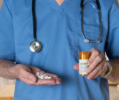 Doctor holding pills