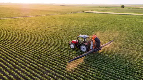 tractor spraying a field