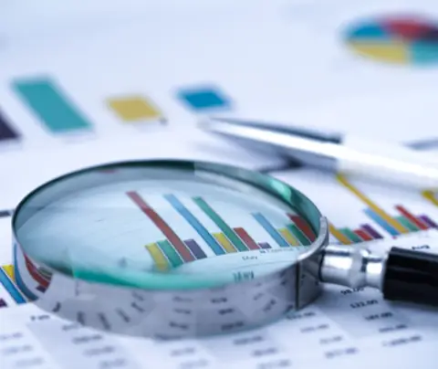 Stock image of research and magnifying glass