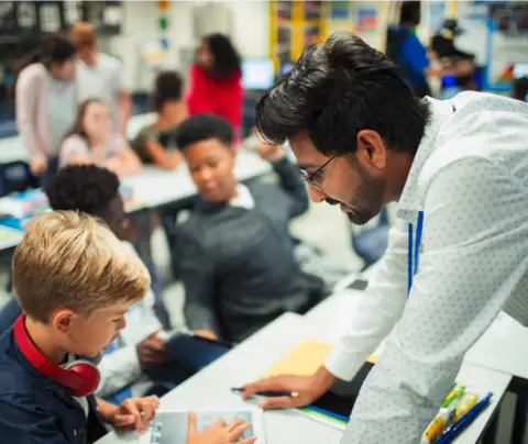 Teacher instructs student
