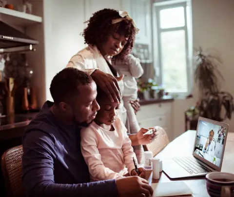 Family consults with doctor via teleheatlh