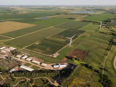Aerial shot of farmland with wind turbines