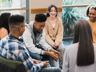 Teenagers seated in circle