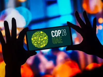 Smart phone with COP28 logo on screen