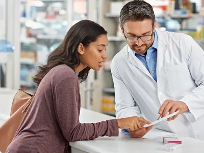 Pharmacist consults customer
