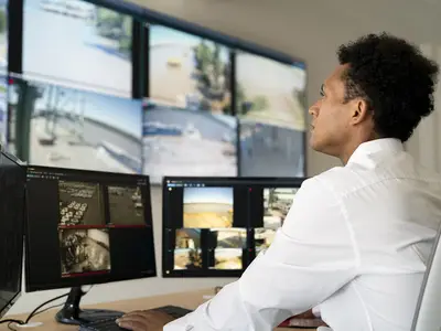 employee checking security footage on monitors