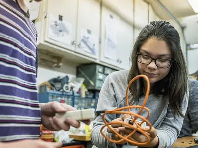 Young student works on project in classroom