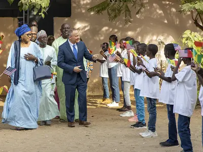 Schoolchildren in Senegal greet officials from the Ministry of Education.