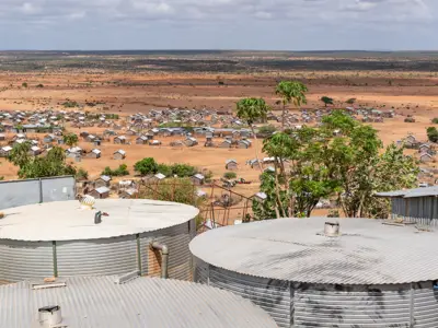 photo of a village in the distance within a dry landscape